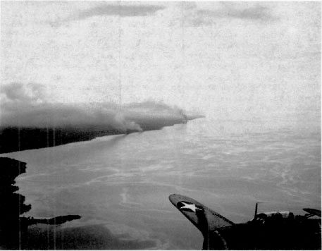 Japanese transports burning on Guadalcanal’s north coast (Point Cruz in left foreground), 15 Nov. 1942. (NA-80-G-30529)
