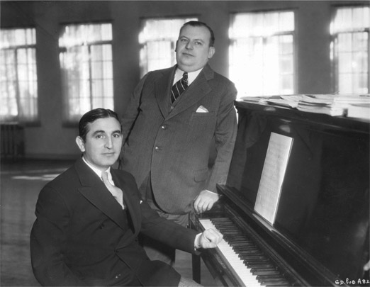 FIGURE 9.2 Composer Harry Warren (seated) and lyricist Al Dubin created the musical sound of the Great Depression. Courtesy of Photofest.