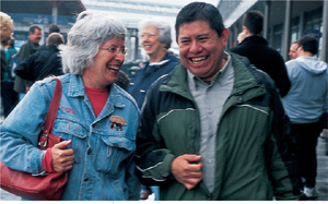 Two people walking through a market