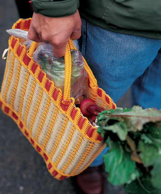 Carrying vegetables in a plastic basket