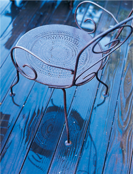 A metal deck chair sitting in the rain