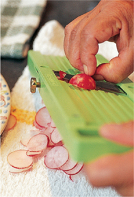 Slicing radishes on a mandoline