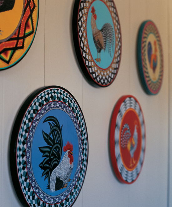 Decorative plates of roosters on a wall