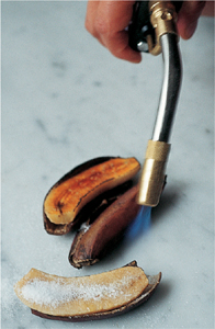 Caramelizing the bananas with a blowtorch