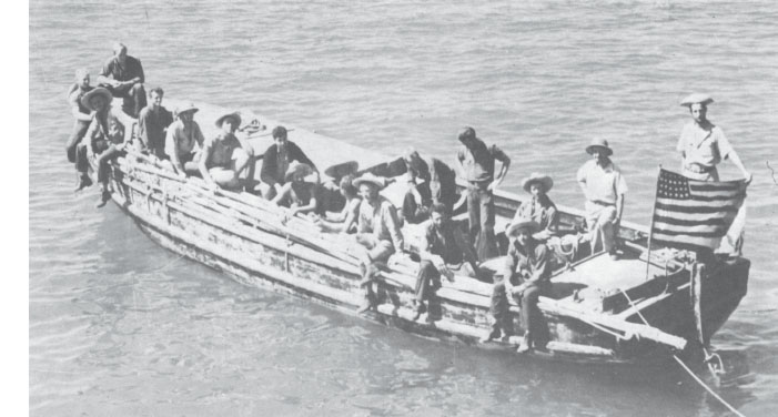 Lieutenant Commander John Morrill, standing in the stern sheets by the tiller, and his seventeen crewmen on board their camouflaged 36-foot motor launch