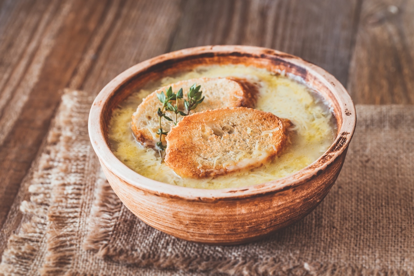 A bowl of food sitting on top of a wooden table Description automatically generated