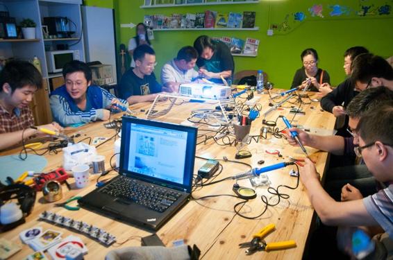 Students learn to solder from Mitch Altman in a class in Shenzhen, China. Photo credit: Mitch Altman.