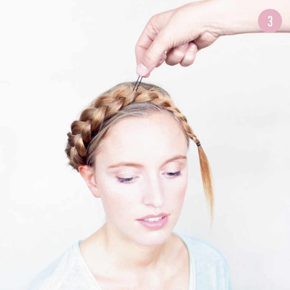 3 Wrap the braid around your head, setting it in place with fringe pins as you go