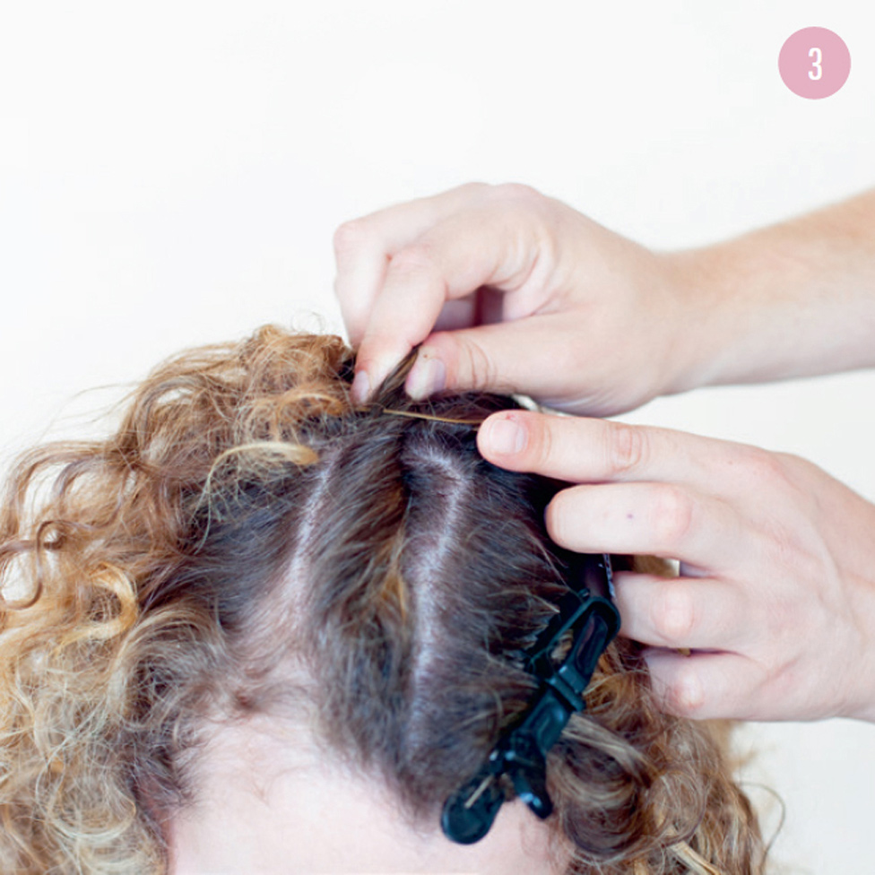 3 Secure the twisted section with a bobby pin, then repeat the process with the other sections of hair