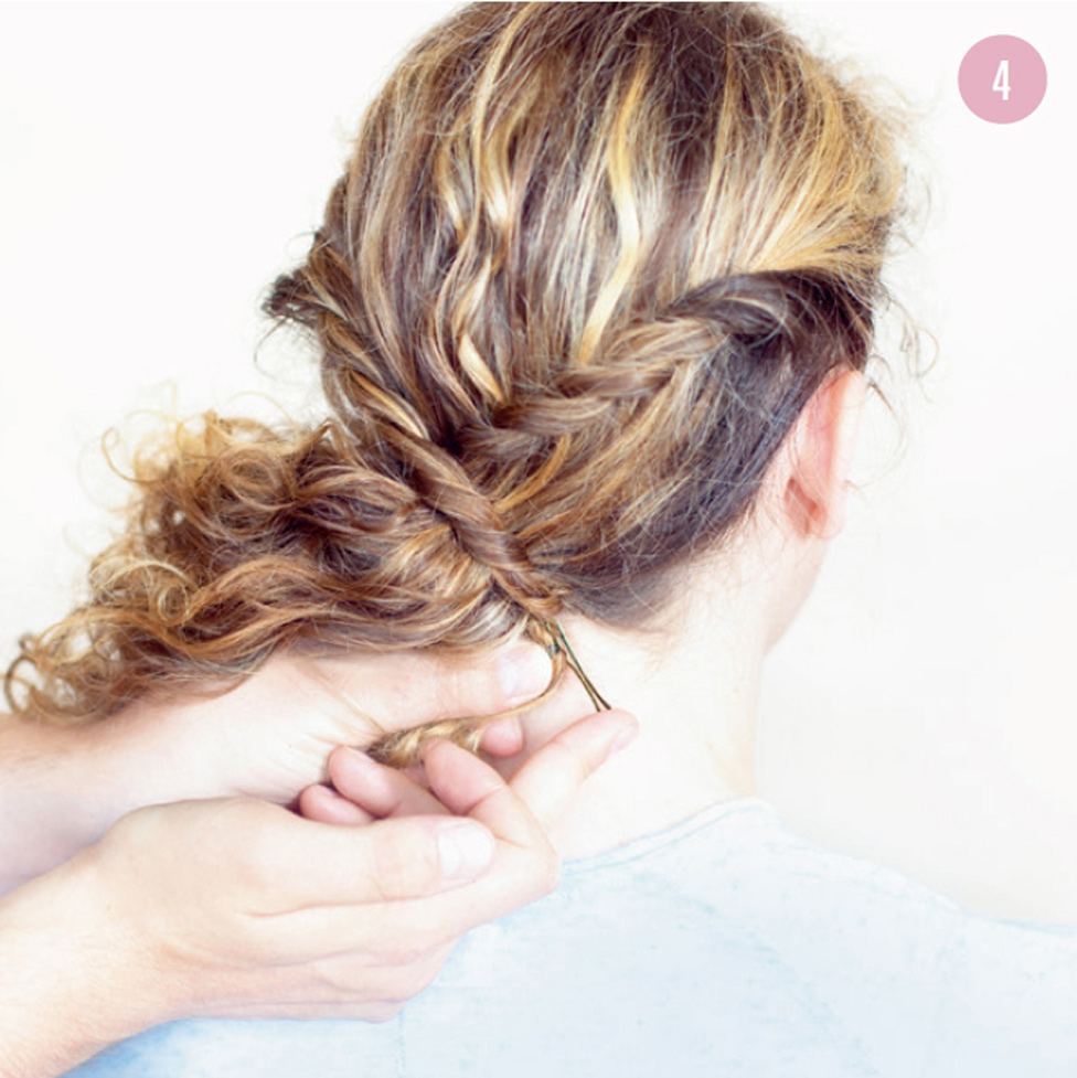 4 Now bring the twists over and around the rest of your hair so that they meet underneath at nape level and secure with bobby or fringe pins, depending on the thickness of the curls