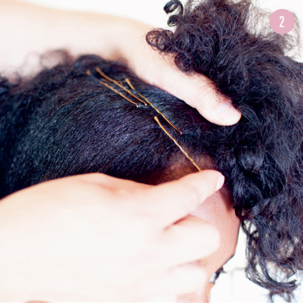 2 Secure the stiff, untreated hair at the top using several bobby pins, half going from front to back and half going from back to front, all along the pouf in progress and ending at the nape of your neck