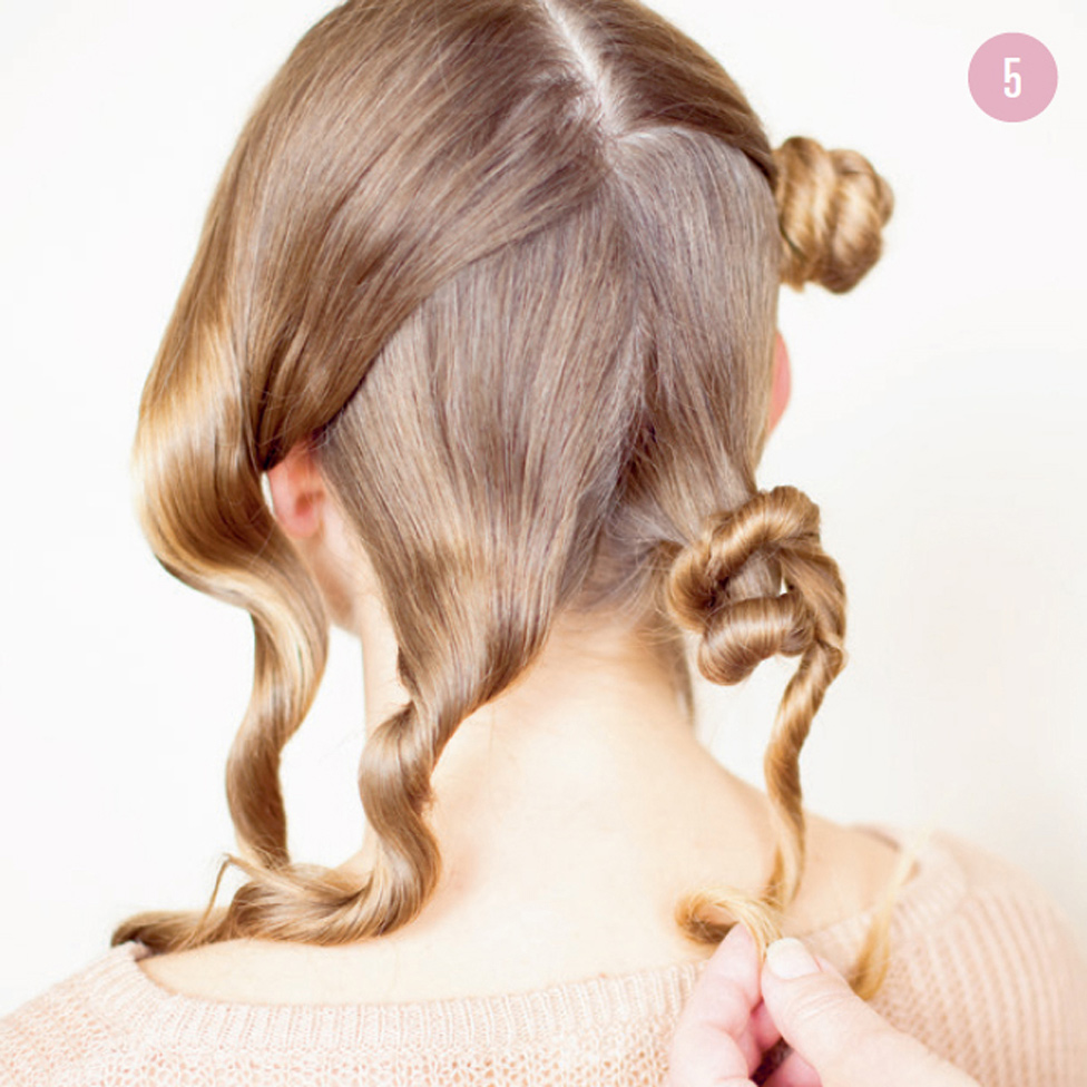 5 Gently unwind the mini buns and pull on each twist to stretch it out. Tousle with your fingers and arrange to your liking, then spritz with hair spray