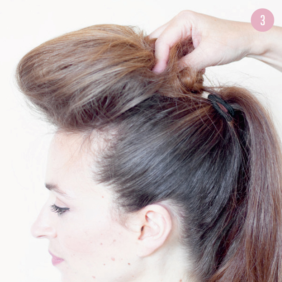 3 Pull the front section back, twirling up the teased ends, then push forward to create the bouffant