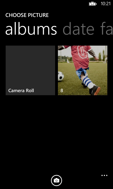 A screenshot of the built-in photo chooser UI. Here, the camera button appears on the app bar.