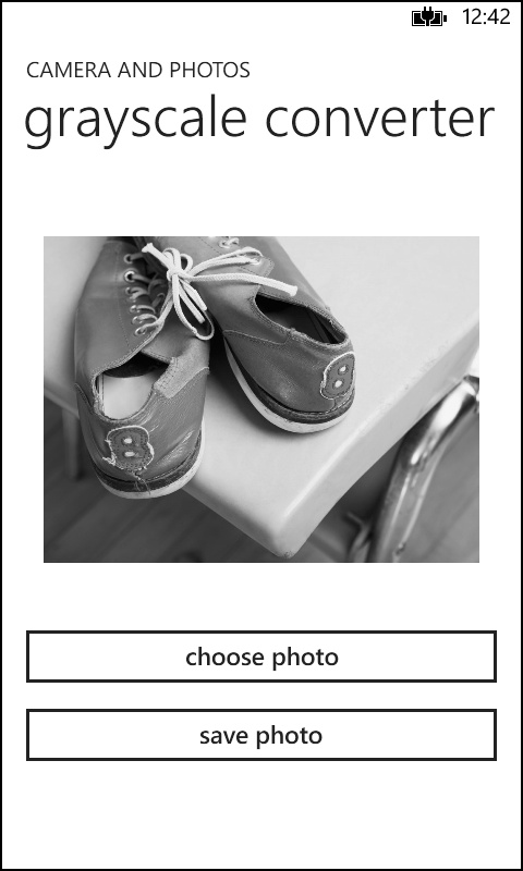 A screenshot of the GrayscalePhotoEditor app. The page shows an image that has been transformed to black and white and includes two buttons, one to choose the image to transform and one to save the modified image back to the user library.