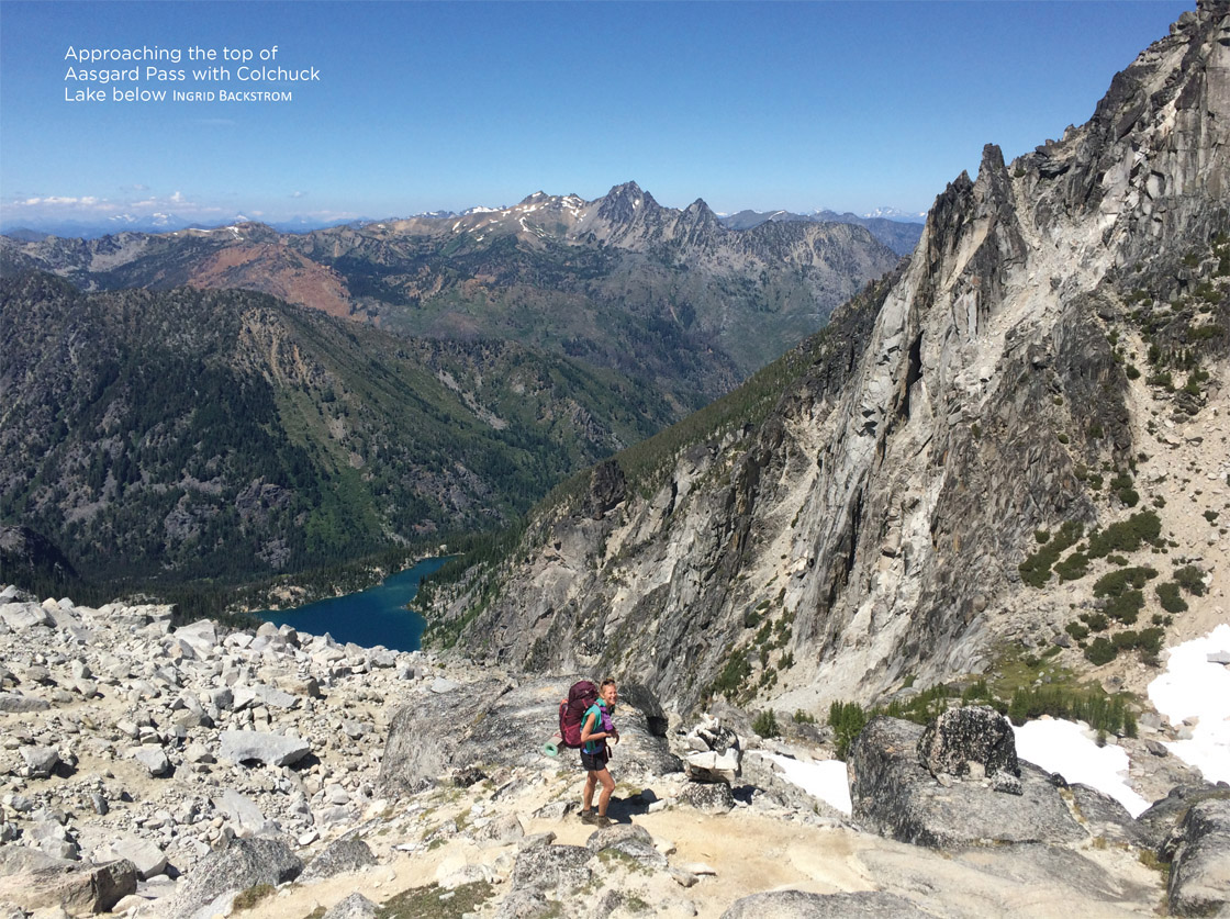 Approaching the top of Aasgard Pass with Colchuck Lake below Ingrid Backstrom