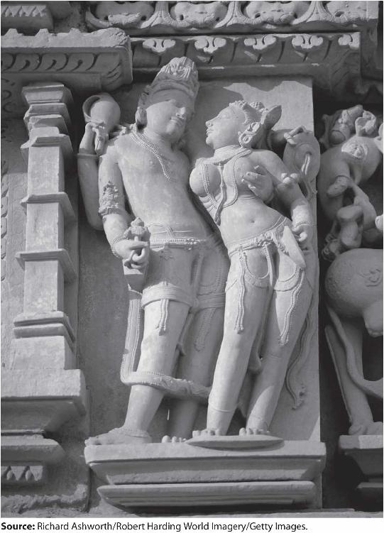 A photo of a statue on a Hindu Temple in Khajuraho shows a couple embracing in a passionate posture.