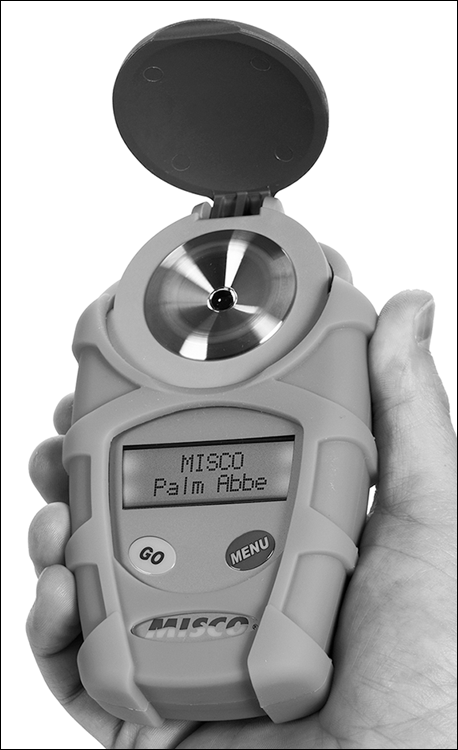 Picture of a hand-held refractometer that is used to measure the water content present in honey.