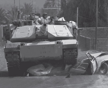 An M-1 tank crushes insurgent suicide vehicle south of Baghdad.