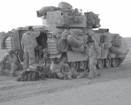 Troops rest in Objective Raiders, waiting for the order to begin the final assault on Baghdad.