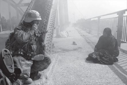 Captain Carter moves under fire to rescue an Iraqi woman shot by the Fedayeen as she tried to cross the Euphrates to safety.