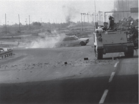 A suicide vehicle rushes 3rd ID armor along the route for Thunder Run II. A moment after this picture was taken the vehicle was torn apart by 25mm cannon.