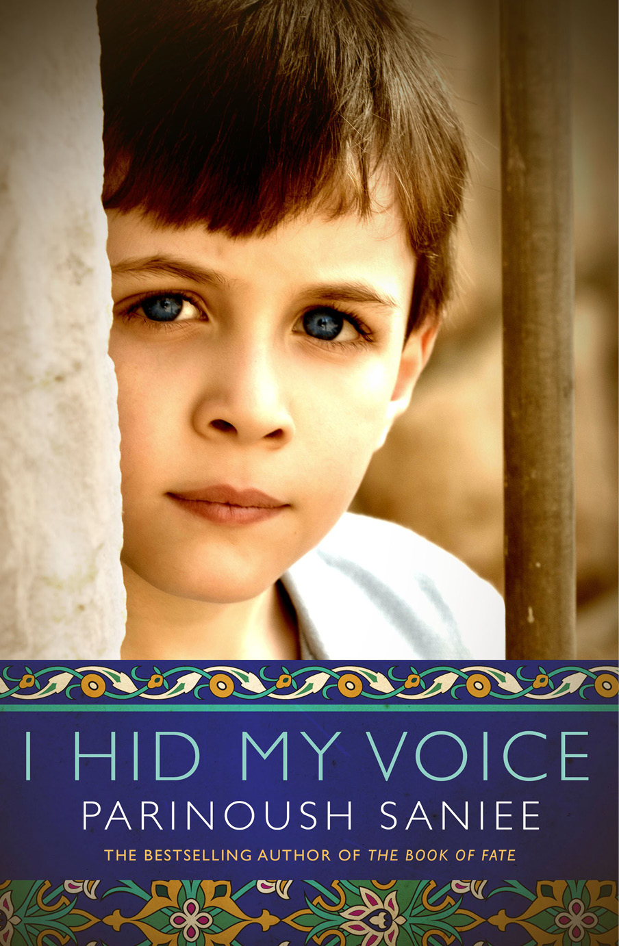 I Hid My Voice cover image shows a photo of a young boy with brown hair and deep blue eyes standing against a wall looking directly into the camera.