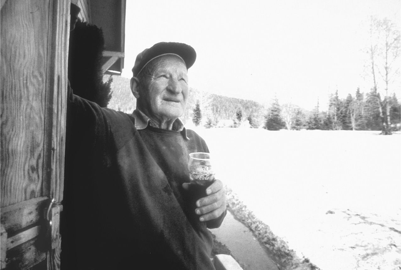 Motormouth Harry Randall Truman, drinking a glass of “panther pee,” at his beloved lodge in the shadow of Mount St. Helens. (Photo courtesy U.S. Forest Service)