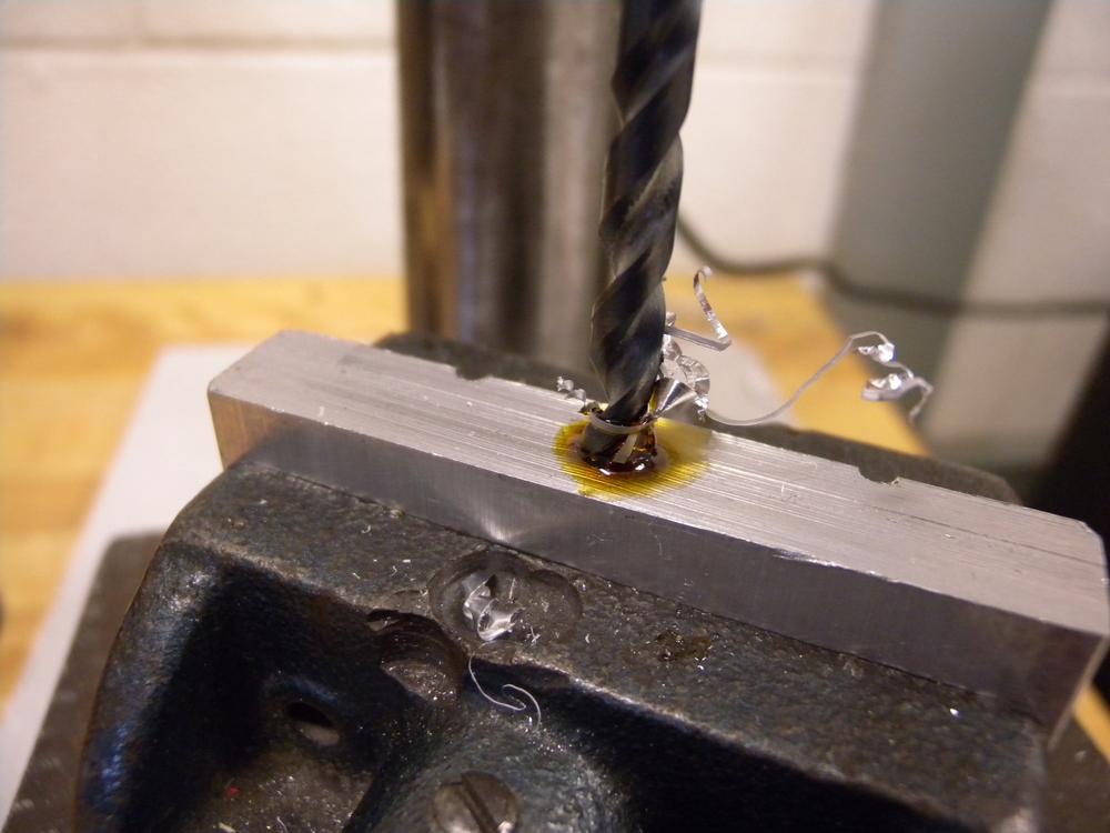 When drilling metal, use plenty of cutting oil and clear the chips often to prevent the bit from overheating.