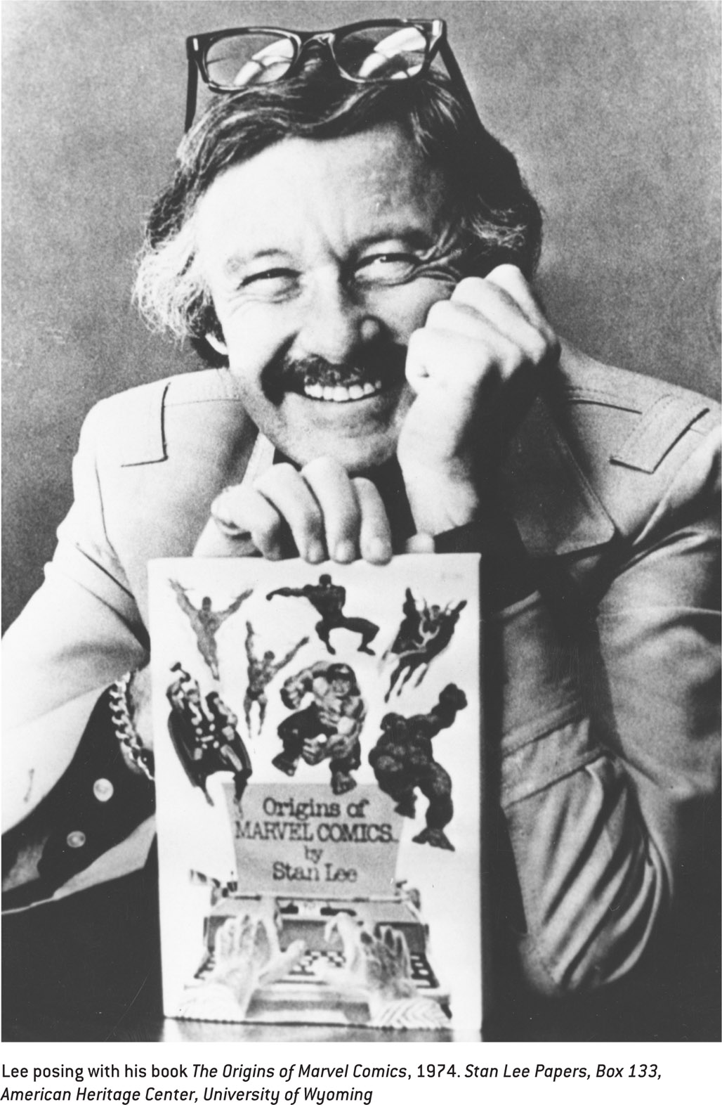 Lee posing with his book The Origins of Marvel Comics, 1974. Stan Lee Papers, Box 133, American Heritage Center, University of Wyoming