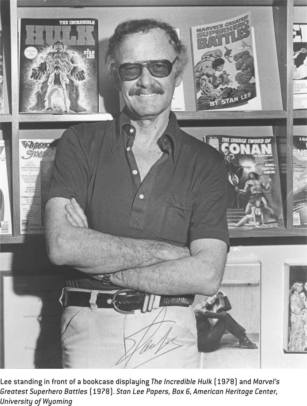 Lee standing in front of a bookcase displaying The Incredible Hulk (1978) and Marvel’s Greatest Superhero Battles (1978). Stan Lee Papers, Box 6, American Heritage Center, University of Wyoming