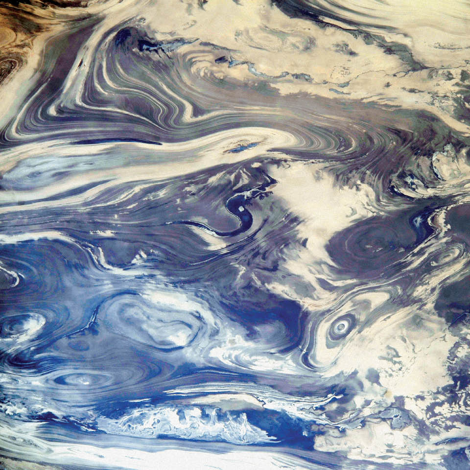 The Kavir desert of central Iran, showing a striking pattern of parallel lines and sweeping curves. The lack of soil and vegetation in the Kavir desert (Dasht-e Kavir) allows the geological structure to appear quite clearly. The dark water of a lake (image center) fills a depression in a more easily eroded, S-shaped layer of rock. A small river snakes across the bottom of this October 2014 photograph taken from the International Space Station.