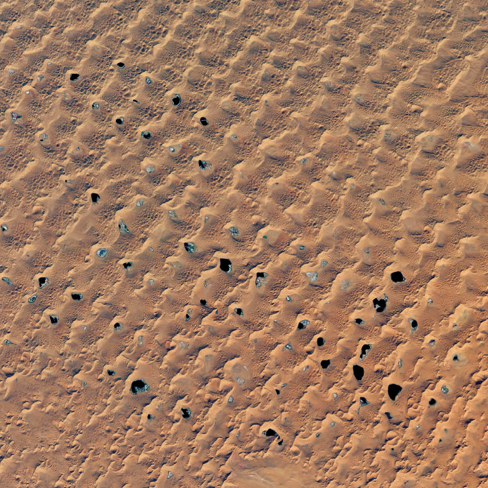 In the Badain Jaran of Inner Mongolia, nearly 100 lakes mingle with the tallest sand dunes in the world. The Badain Jaran naturally piles up megadunes towering 200 to 300 meters (650 to 1,000 feet) tall.