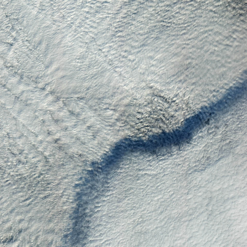 In November 2012, the Earth Observing-1 satellite acquired this image of a layer of clouds casting a distinctive shadow on another, lower cloud layer. The upper deck was more than 1 kilometer (0.6 miles) above the ground. Both layers were composed of stratus clouds, a low-lying type that tends to be uniform and flat. When the satellite’s Advanced Land Imager acquired the image, the clouds were over northeastern Germany near Harz National Park.