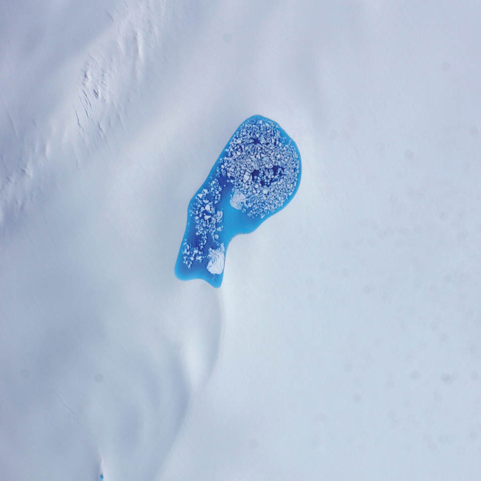 As temperatures rise in the summer, turquoise splotches of color begin to speckle the icy surfaces of the Arctic. Those splashes of blue are melt ponds—areas where snow has melted and pooled in low spots atop glaciers and sea ice. During an airborne research campaign in July 2014, a scientist shot this photograph while flying over a glacier in southeastern Alaska. Chunks of ice float on the pond’s turquoise water.