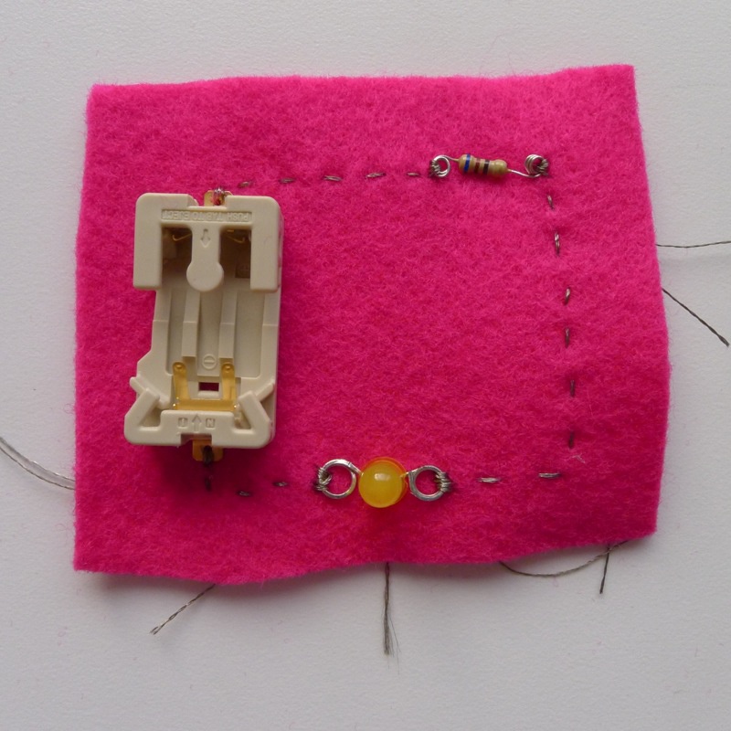 Thread #3 connects the LED and the negative terminal of the battery holder, completing the circuit