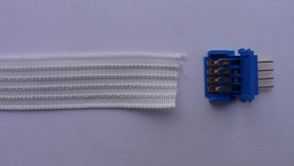 Four-conductor conductive ribbon with crimp connector; this ribbon is lighter weight and has the advantage of the conductors being insulated, meaning you can fold the ribbon against itself without creating shorts