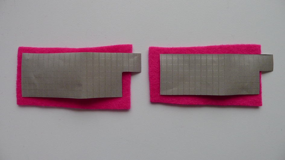 Cut two patches of conductive fabric that are slightly smaller than the pieces of nonconductive fabric; include a tab long enough so that it can wrap around an edge