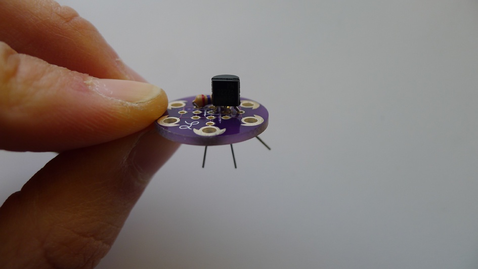 Push the legs through so that the head of the transistor sits close to the surface of the board