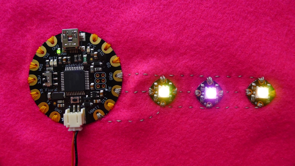 Flora with three NeoPixels sewn with conductive thread