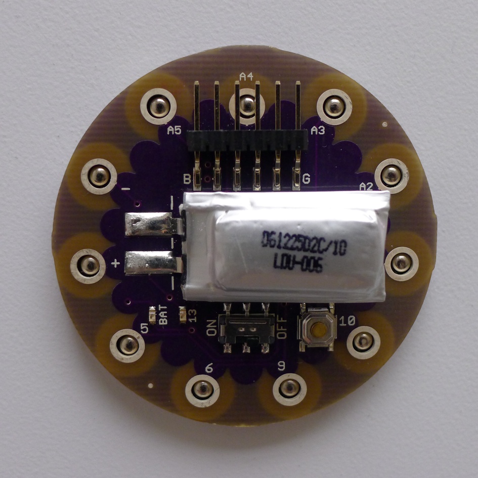 LilyPad Arduino SimpleSnap (front) with lithium polymer battery