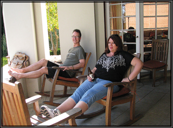 Picture of S.G. Browne and E.S. Magill are relaxing on the front porch.