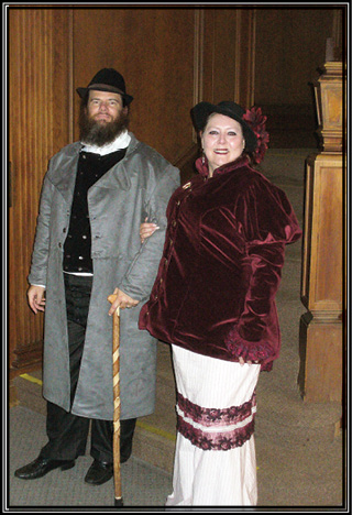 Picture of William Gilchrist and Kim Richards dressed in 1890’s inspired costuming.