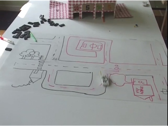 Sketch-a-Move, a toy concept video. Small magnets under the table create the illusion that players are controlling the movement of toy cars by drawing on them; view the video at (image: Anab Jain, Superflux).