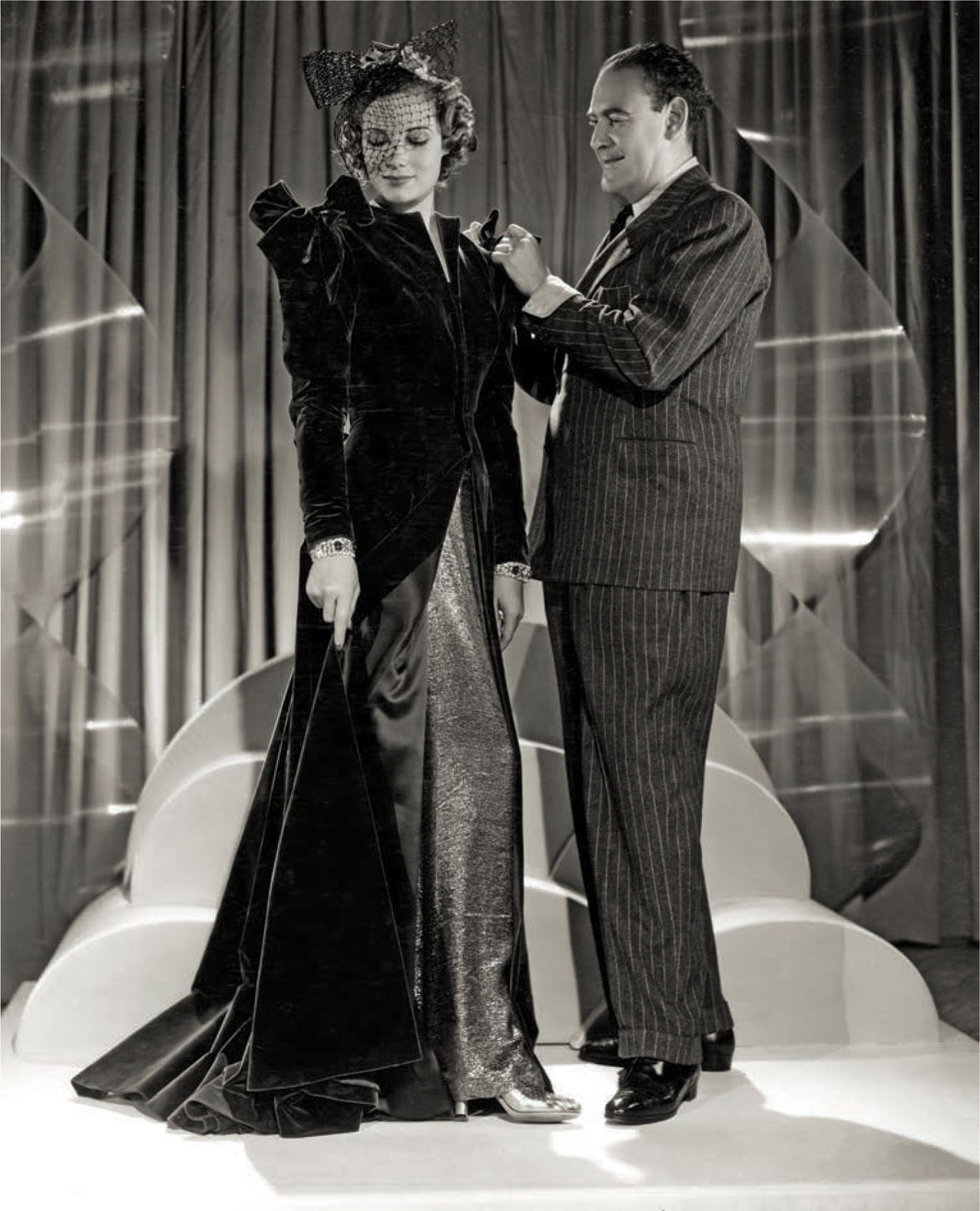 Designer Omar Kiam fits Betty Thomas for Vogues of 1938 (1937).