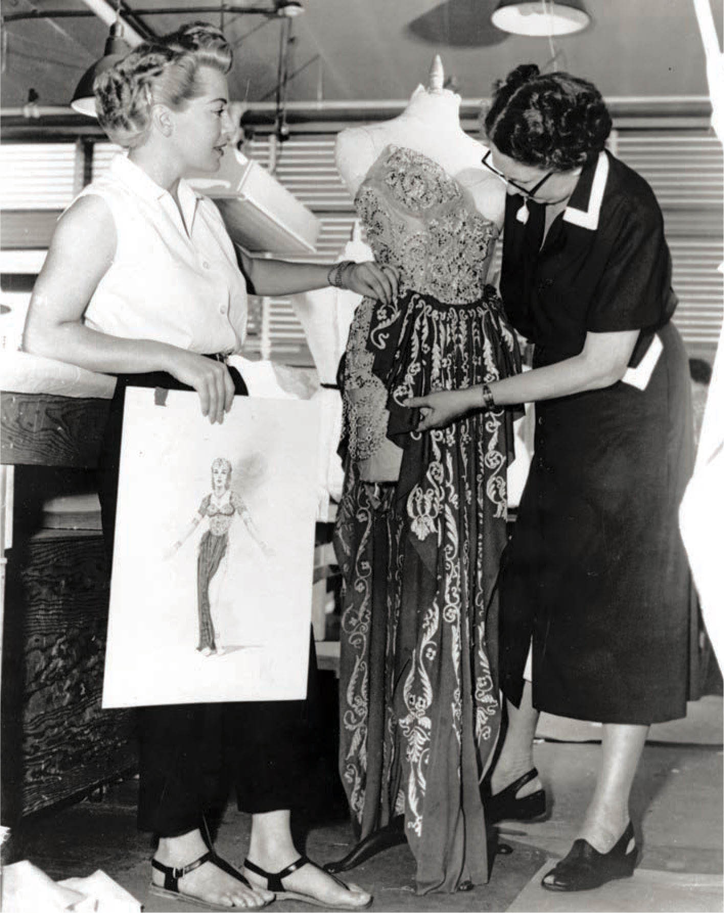 Lana Turner checks on the progress of a dress for The Prodigal in the workroom at MGM.