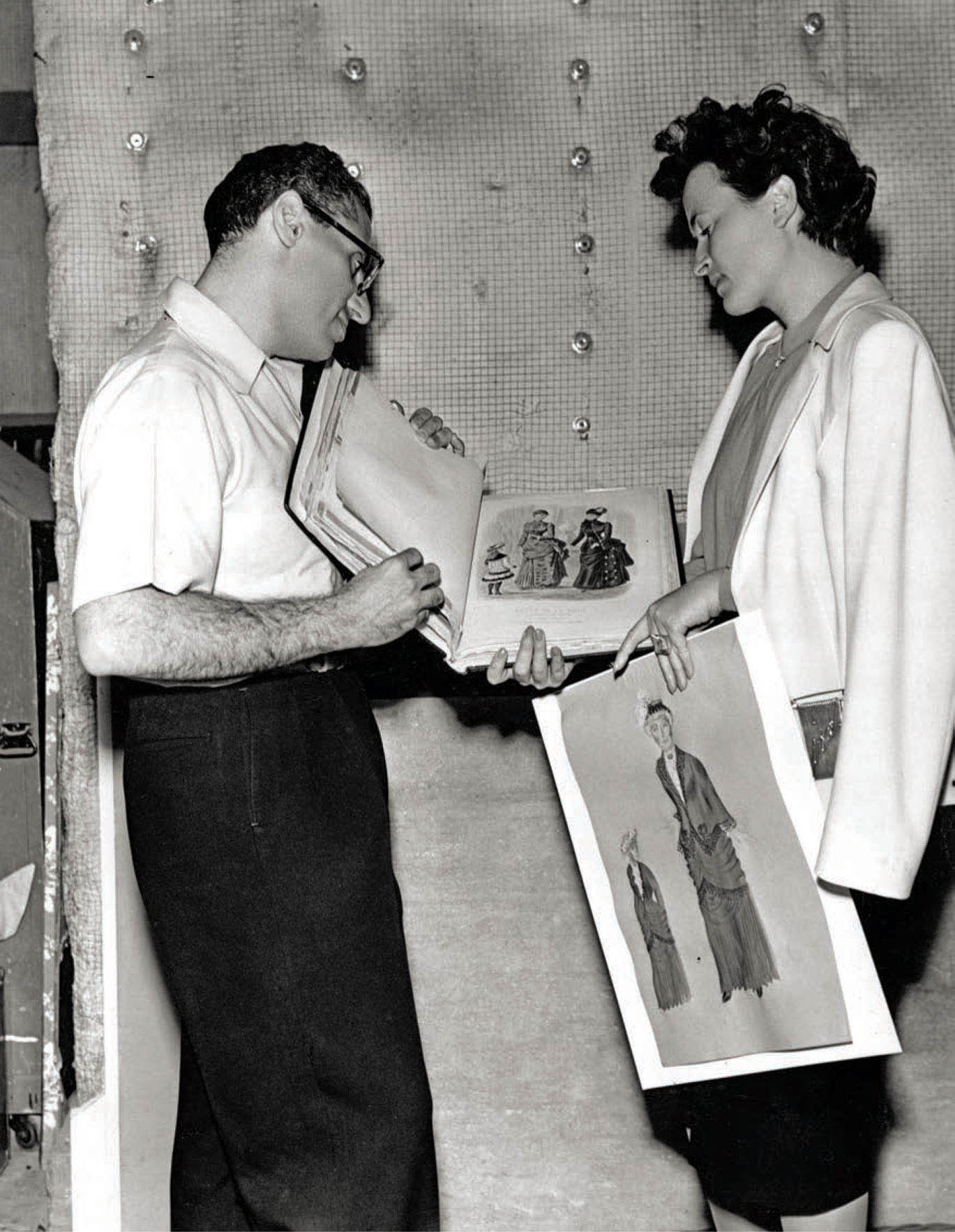 Director George Cukor and Irene look over a copy of Godey’s Lady’s Book, the inspiration for many of Irene’s designs for Ingrid Bergman in Gaslight.