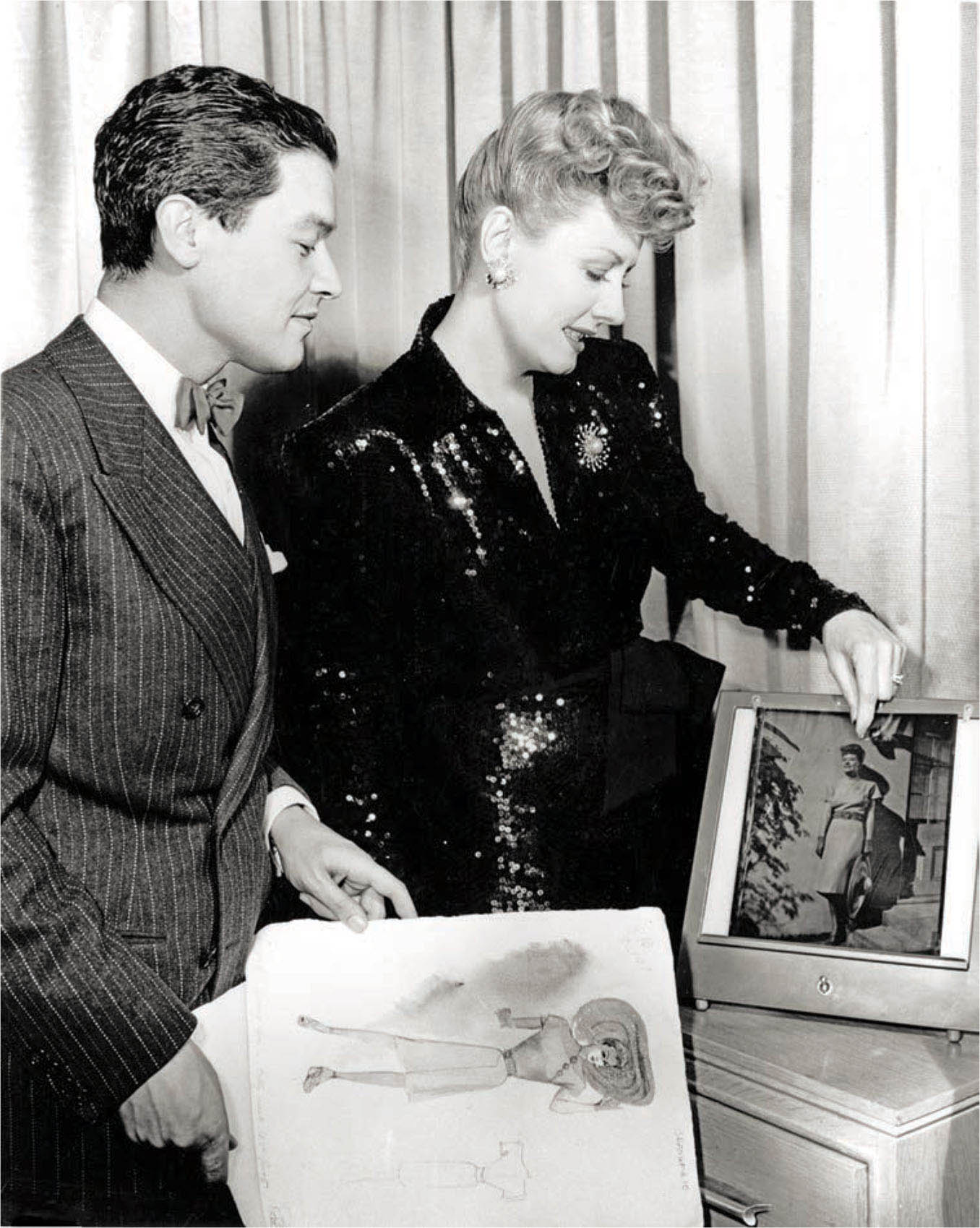 Jean Louis discusses the wardrobe for Over 21 (1945) with actress Irene Dunne.