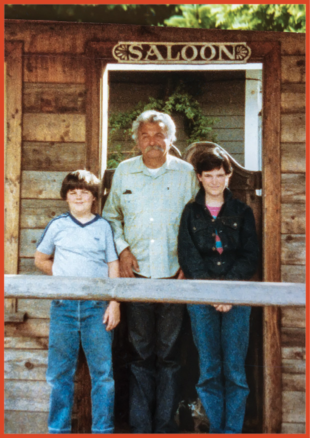 image of grandfather and his two grandsons standing outside a saloon