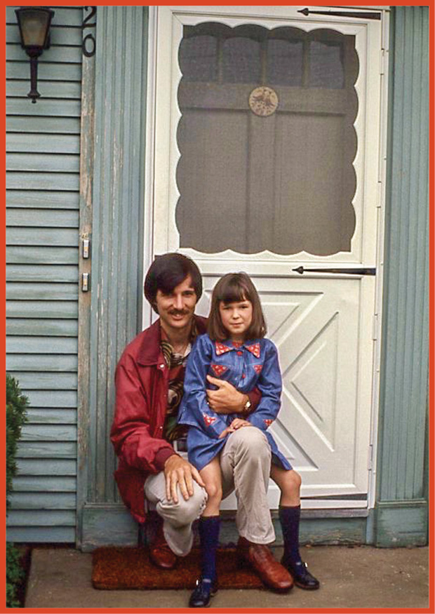 image of a father and daughter sitting outside a house